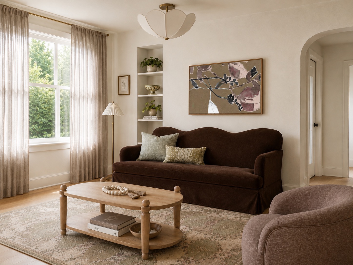 Living room with a brown scalloped sofa, patterned rug, and botanical art